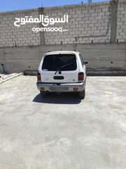  1 كيا سبورتاج موديل 2000 لون ابيض ماتور 2000 توماتيك