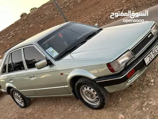  1 مازدا 323 موديل 1986 على وضع الشركه محرك 1500 قير عادي كول شي شغال 100 بل 100