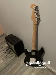  4 Electric guitar(Black and white) and Amplifier.  غيتار كهربائي(اسود و ابيض) و مكبر للصوت