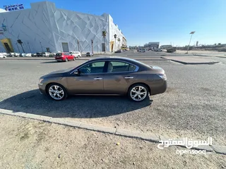  2 Nissan Maxima, brown color, made in 2014.