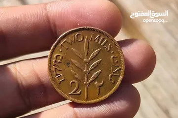  7 عملة فلسطينية تاريخية نادرة من فئة 2 مل صادرة عام 1927 خلال فترة الانتداب البريطاني على فلسطين.