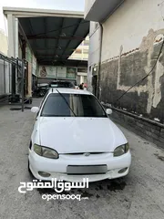  9 اكسنت 97 لون ابيض فيها ضربه بالجناح