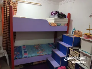 2 سرير أطفال طابقين مع درج فيه كبتات