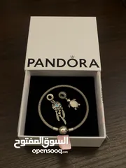  1 PANDORA bracelet, for sale, plus two charms as a gift. price for all 60 dinars
