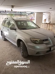  1 ميتسوبيشي آوتلاندر 2006 للبيع بحالة ممتازة موتور 2400 جير توبترونك دفع رباعي جلد فتحة وفتحة ثانية با