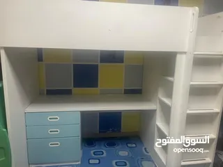  1 Ikea loft bed with a closet, three drawers, and adesk. تخت اكية عالي مع خزانة و مكتب و جرارات و رفوف