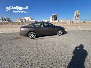  1 Nissan Maxima, brown color, made in 2014.