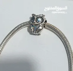  8 PANDORA Silver bracelet with heart-shaped clasp with some charms سوار باندورا فضة بشكل قلب مع إضافات