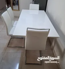  6 white  dining table with 6 chairs.