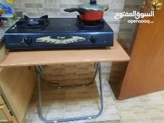  1 Gas stove along with table