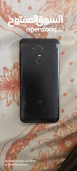  3 Redme note 5 plus black with headphones and a cover