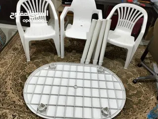  3 طاولة بلاستيك مع ثلاثة كراسي ومظلة