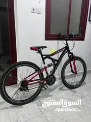  1 two bicycles Full-suspension mountain bike with a 27 red and black