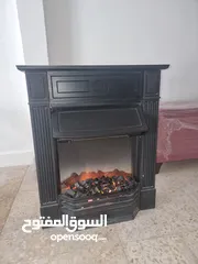  1 صوبة كهرباء على شكل موقد حطب مستعملة