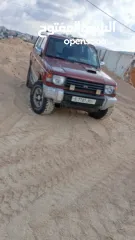  1 ميتسوبيشي باجيو1999  جير اتوماتيك 7 ركاب غرفه جلد عسليه  جير ومطور جاد مركبات