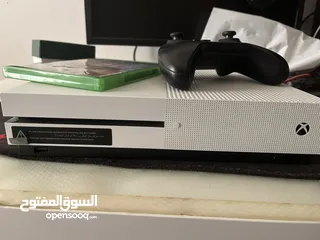  4 Xbox one s 1TB with a controller and a CD