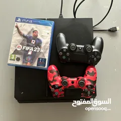  1 PS4 , a cd for FIFA 23 and 2 pads on it