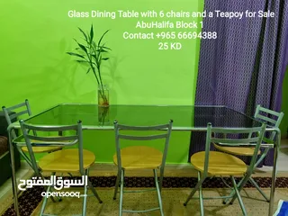  1 Glass Dining Table with 6 chairs and a teopoy