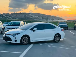  18 تيوتا كورولا هايبرد ترخيص 2022 فل بدون فتحة مميزة  ماتور 1800cc ( بنزين + كهرباء) 170Hp