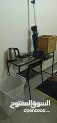  1 Ikea table + chaire + Landry basket + basket of clothes + vacuum + water hotter and toast cooker