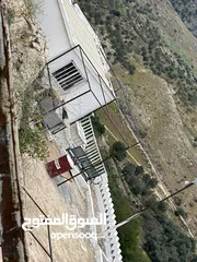  1 استراحة استثماريه للبيع مطله على وادي الريان قوشان مستقل 3،5 دونم مشجرة بالكامل مع مواقف سيارات