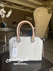  2 Original brand new GUESS cross body bag with original tag. Shipped all the way from America to Amman