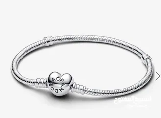  11 PANDORA sliver bracelet with heart shaped clasp with some charmsاسواة باندورا فضة بشكل قلب مع إضافات