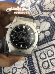  1 Hublot black and silver color watch