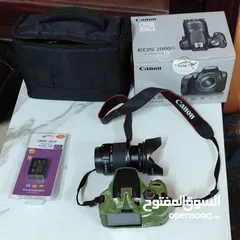  1 كاميرا كانون D2000 مستعملة شهر شبه جديده مع كرتونتها شتر اقل من1000