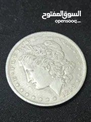  1 هذه العملة هي دولار مورغان (Morgan Dollar) أمريكي