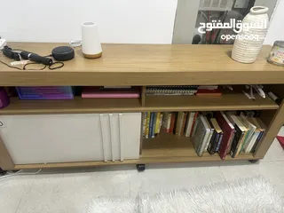  2 A fairly used tv stand with book shelves,