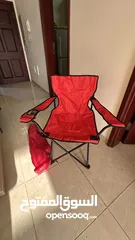  1 كرسي تخييم احمر جديد -"Red camping chair, new."