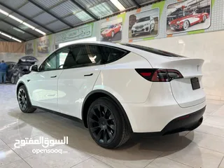  10 Tesla Model y Long Range Dual Motor 2023 ممشى 18 الف اللون الخارجي والداخلي ابيض جنط بيرفورمانس