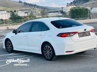  19 تيوتا كورولا هايبرد ترخيص 2022 فل بدون فتحة مميزة  ماتور 1800cc ( بنزين + كهرباء) 170Hp