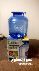  1 New crystal color water dispenser available in excellent condition.