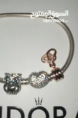  8 PANDORA sliver bracelet with heart shaped clasp with some charmsاسواة باندورا فضة بشكل قلب مع إضافات