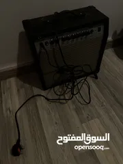  5 Electric guitar(Black and white) and Amplifier.  غيتار كهربائي(اسود و ابيض) و مكبر للصوت