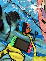  6 نينتيندو سويتش + 2 joy con إضافيتان مع شمعة مع مسكتين مع اغراضه ( بدون ألعاب )و شنتة