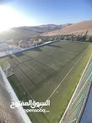  29 فرصة استثمارية لا تعوض ارض 14 دونم مع ملعب قدم خماسي باعلى المواصفات ، مرافق وصاله كبيره وتراس خارجي