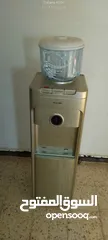  1 كولر ماء مستعمل + قارورة سحرية جديدة غير مستعملة