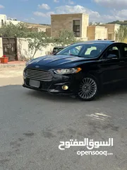  6 فورد فيوجن 2014 هايبرد تيتانيوم فل اضافات ماشيه 70 الف فقط بحاله الشركة