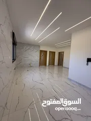  25 شقه طابق ارضي 144متر مع ترس 30 متر للبيع في جبيهه حي المنصور بموقع مميز
