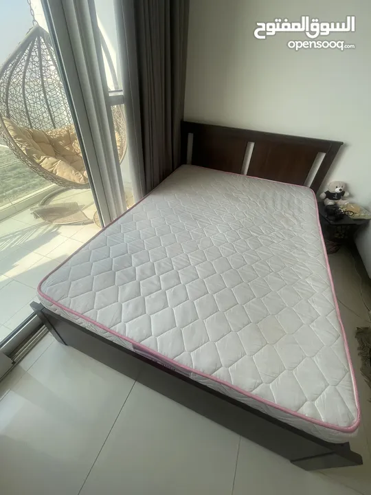 Bed with mattress along with book shelves