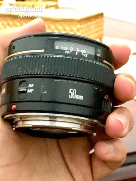 عدسة كانون 50mm f1.4+حقيبة+هود