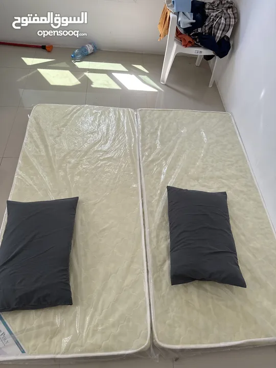 Two mattresses with two pillows