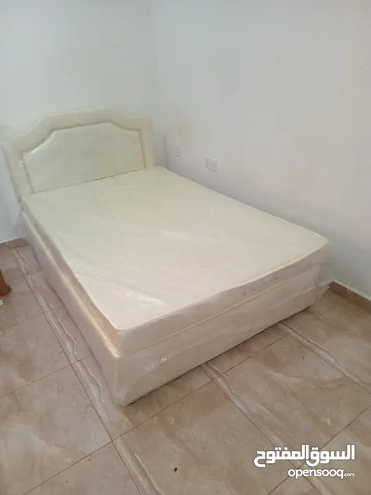 bed with mattress + a chair and a plastic table like new with a used wardrobe