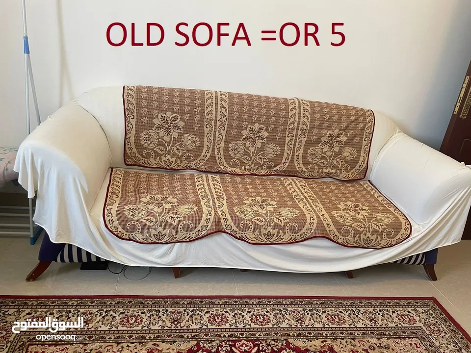 an old three seater sofa and a Turkish carpet.