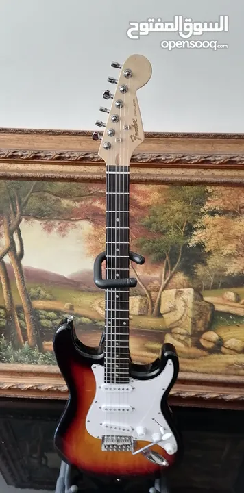 Fender electric guitar stratocaster replica with 10 watt amplifier.