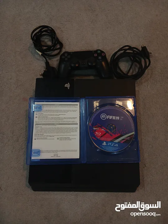 PlayStation 4 with controller, FIFA 19 and cables