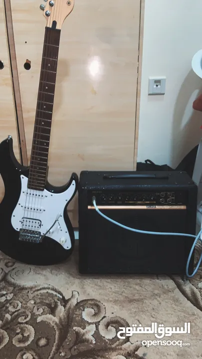 Guitar with amp and cable and case